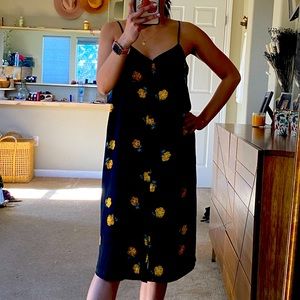 Dress black with yellow/orange flowers printed.